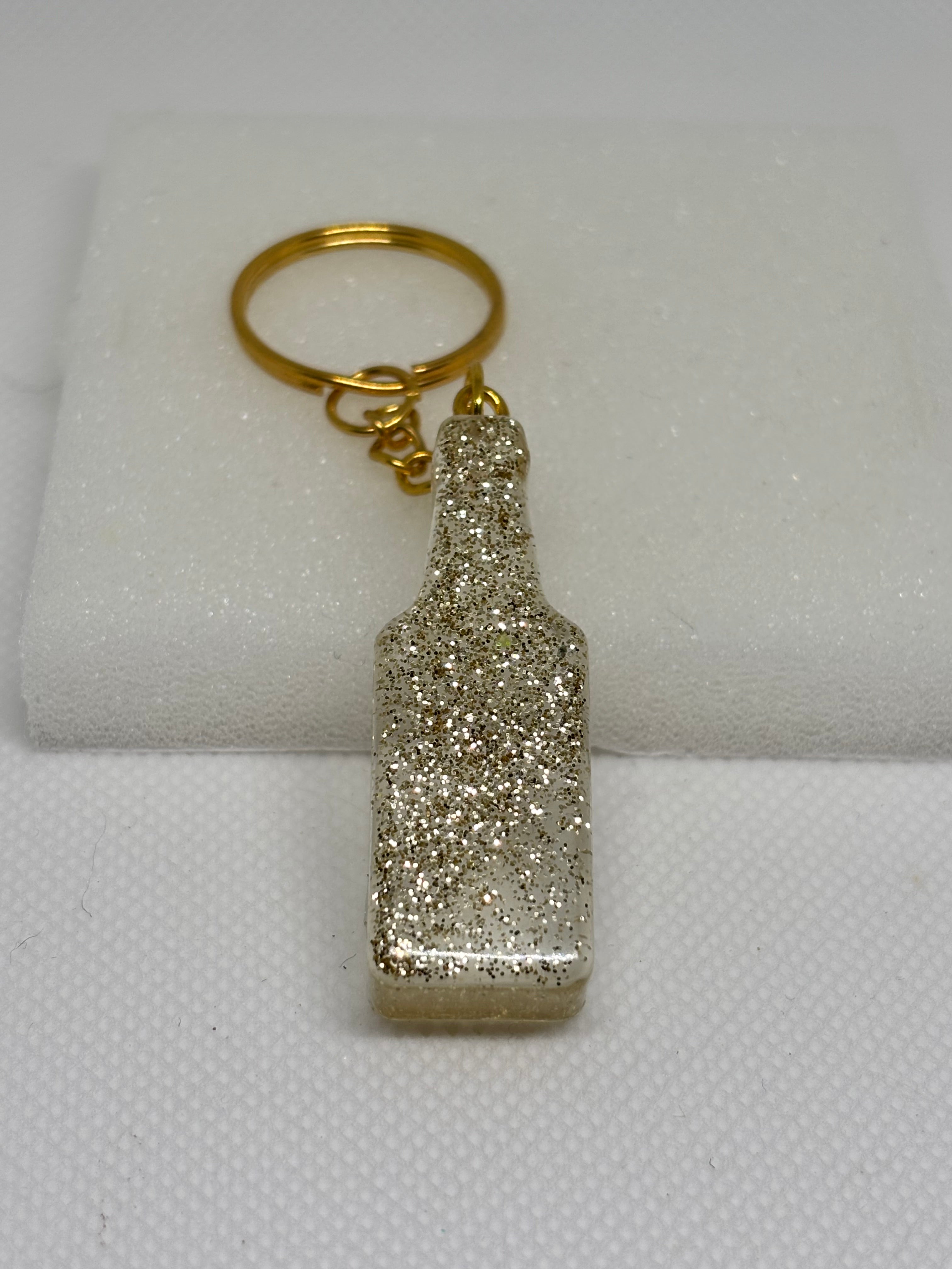Porte-clé bouteille en résine transparente et paillettes dorées