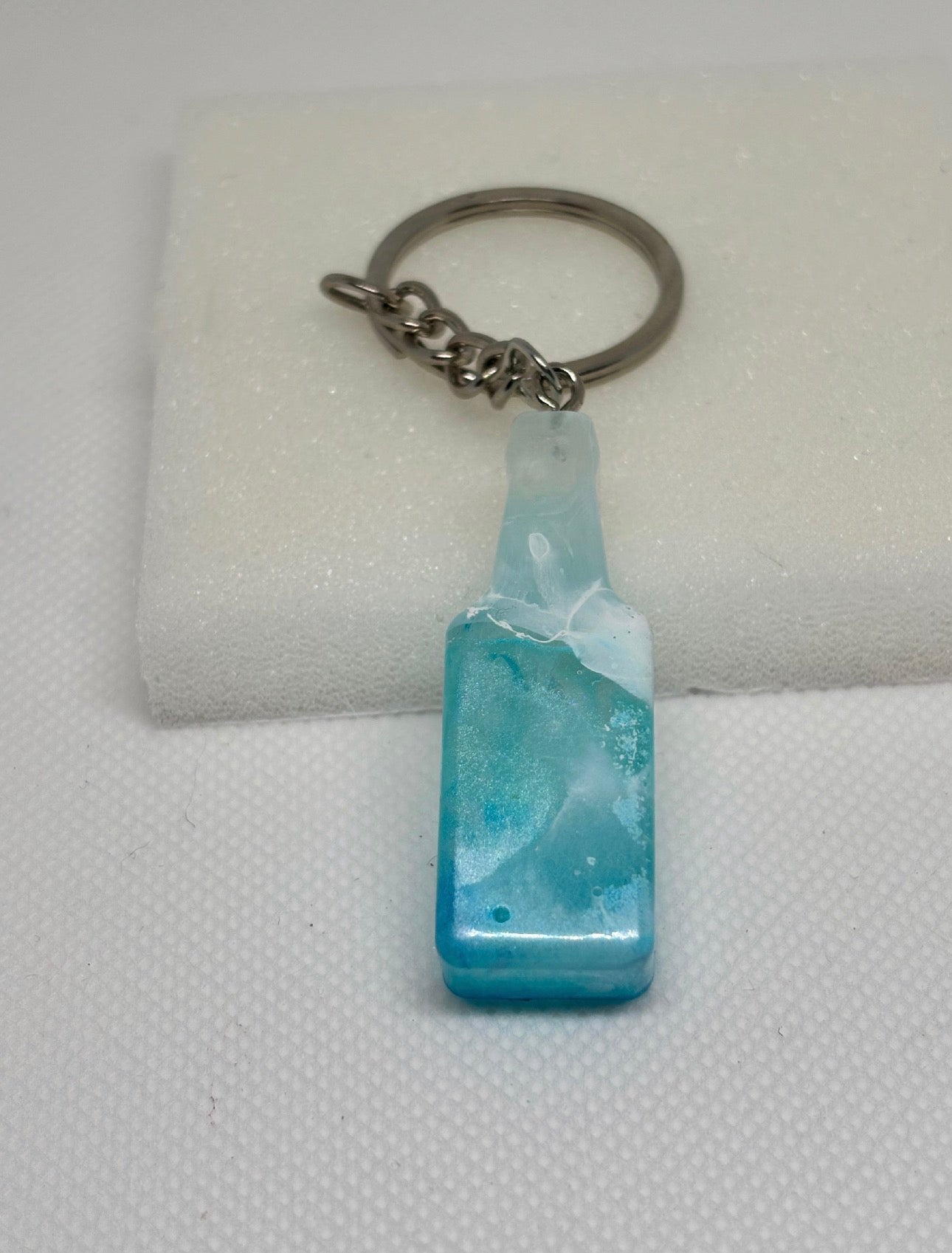 Porte-clé bouteille en résine transparente et paillettes dorées